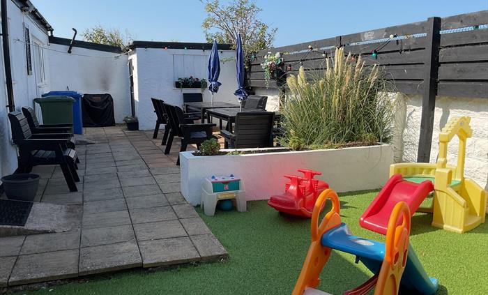 Secure rear garden with patio furniture